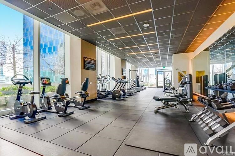 A gym with exercise equipment and a large window.