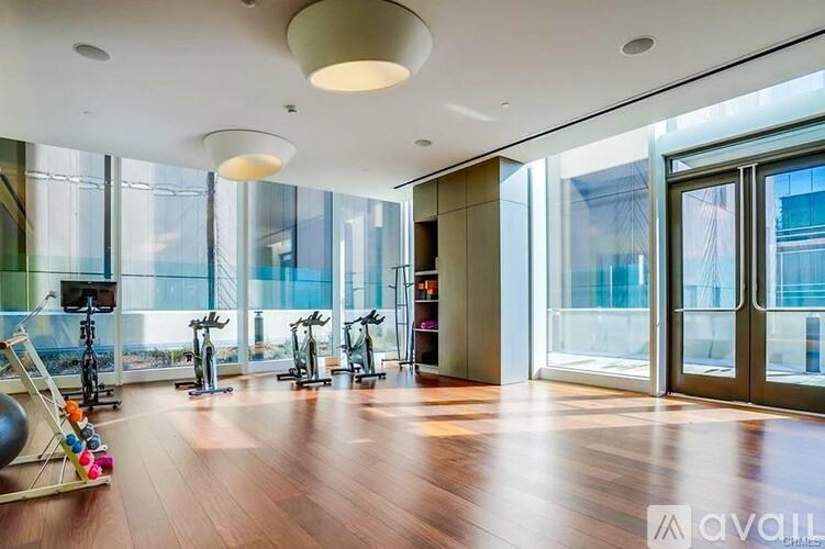 A gym with exercise equipment and a large window.