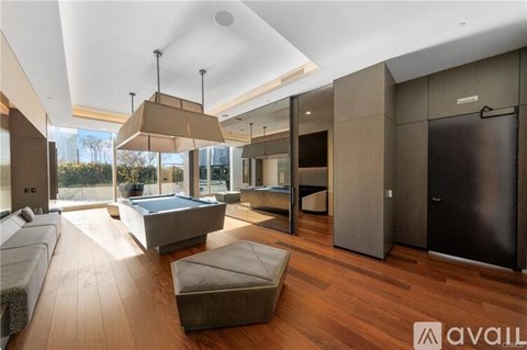 A modern living room with a large sofa and a wooden floor.
