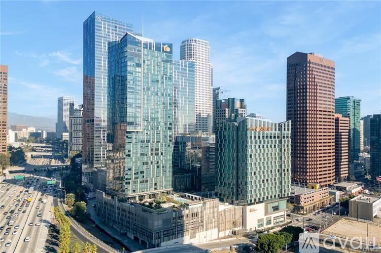 A cityscape with a large glass building in the foreground.