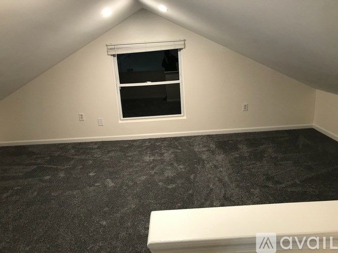 A room with a window and a bench.