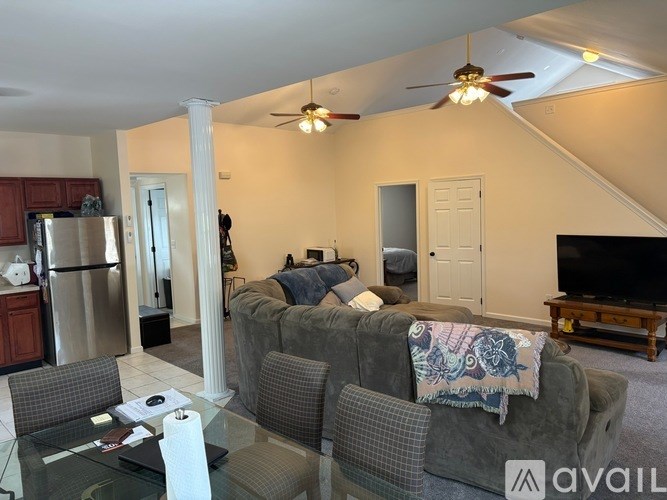 A living room with a grey couch and a television.