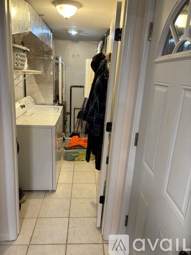 A white door is open to a small bathroom with a sink and a mirror.
