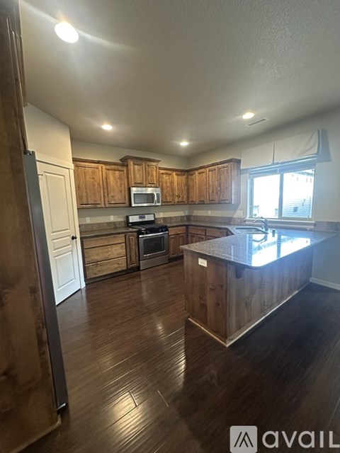 A kitchen with wooden cabinets and a countertop.