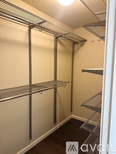 A walk-in closet with shelving and a door.