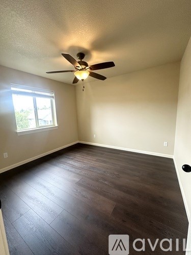 A room with a ceiling fan and a window.