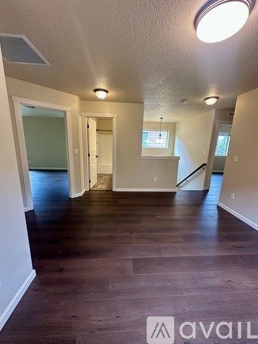 A room with wooden floors and white walls.