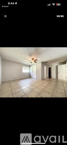 A room with tiled flooring and a ceiling fan.