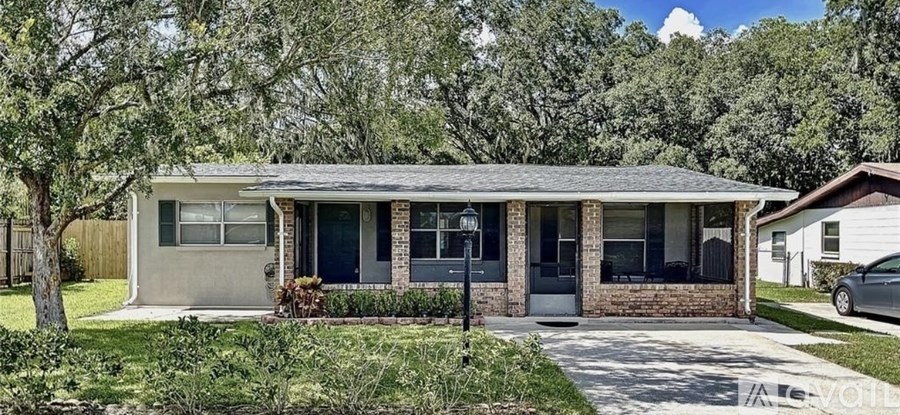 A house with a grey roof and a white fence.