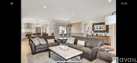 A modern living room with a large sectional sofa and a coffee table.