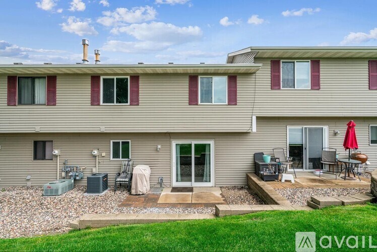 A house with a patio and a red umbrella.