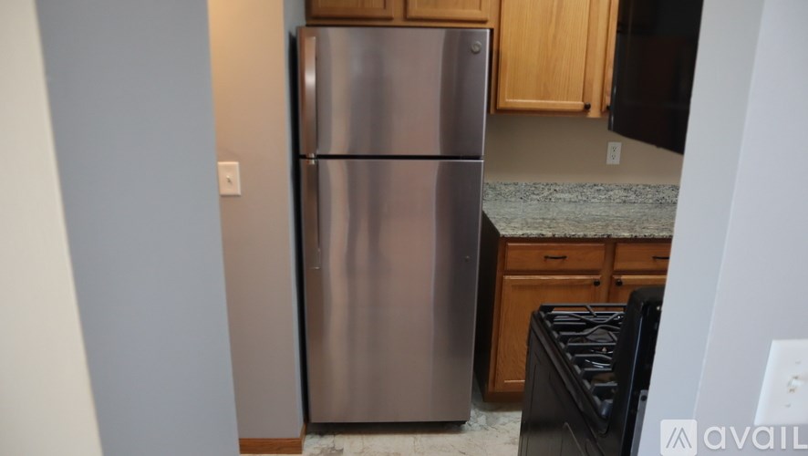 A stainless steel refrigerator in a kitchen.