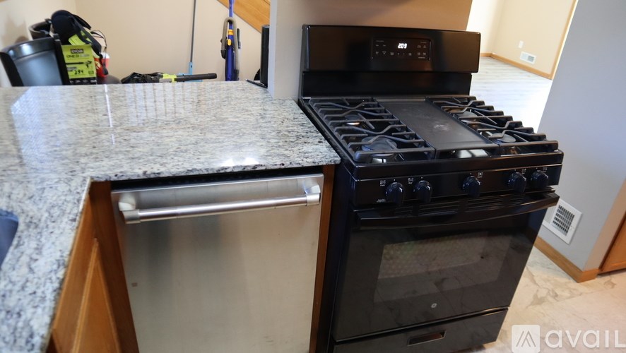 A black stove top oven with a silver drawer underneath it.