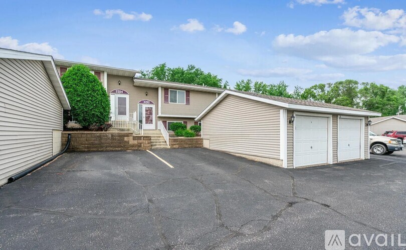 A parking lot with a building and a car parked in front.