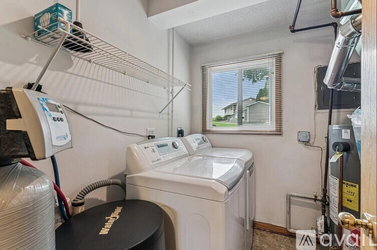 A small laundry room with a washer and dryer.