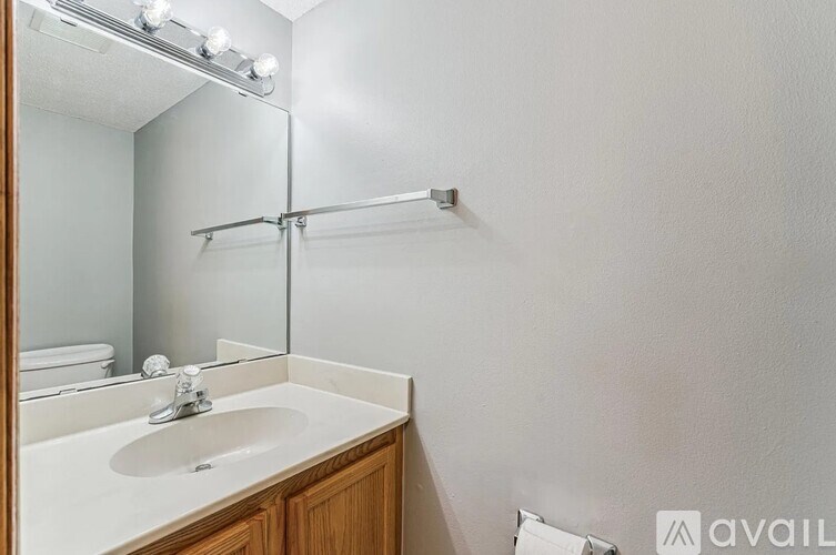 A bathroom with a sink, mirror, and lights.