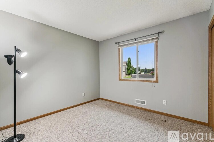 A room with a window showing a tree outside.