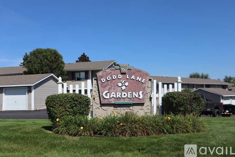 A sign for Boulder Lane Gardens is displayed in front of a building.