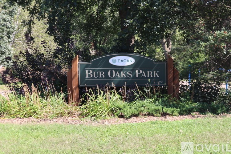 A green sign that says Bur Oaks Park.