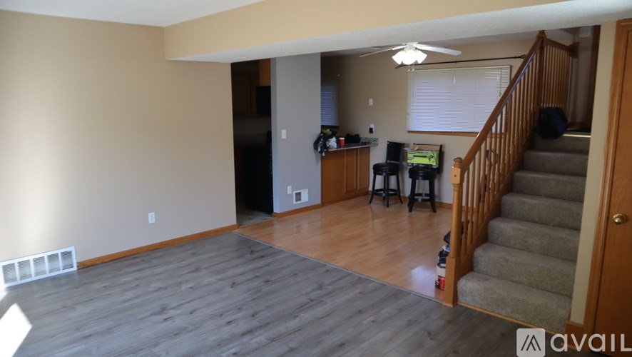 A living room with a staircase leading to the upper floor.