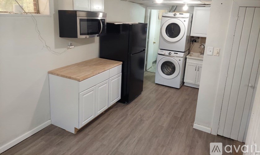 A room with a white door and a light on the ceiling.