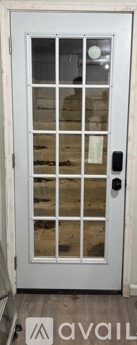 A white door with a glass panel and a black handle.