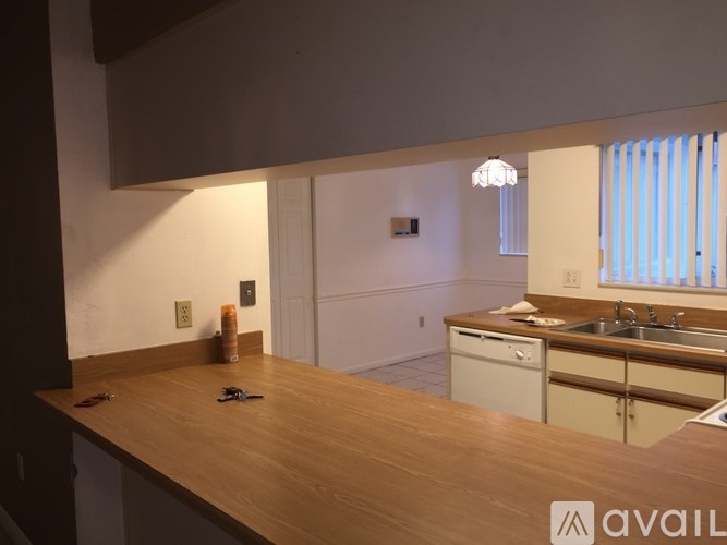 A kitchen with a wooden countertop and white cabinets.