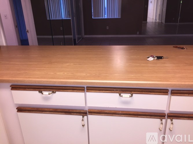 A wooden countertop with a drawer and a handle.
