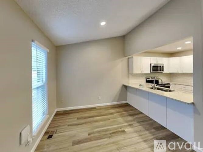 A kitchen area with a countertop and cabinets.