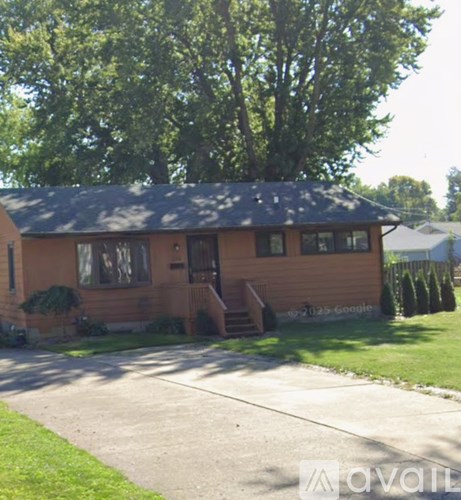 A house with a brown exterior and a black roof.