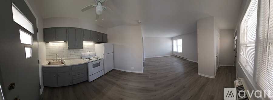 A kitchen with a sink, stove, and cabinets is shown in this image.