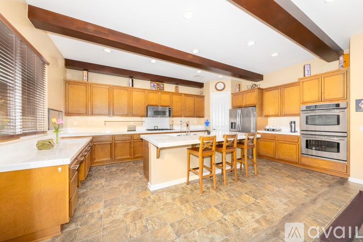A kitchen with wooden cabinets and a central island.