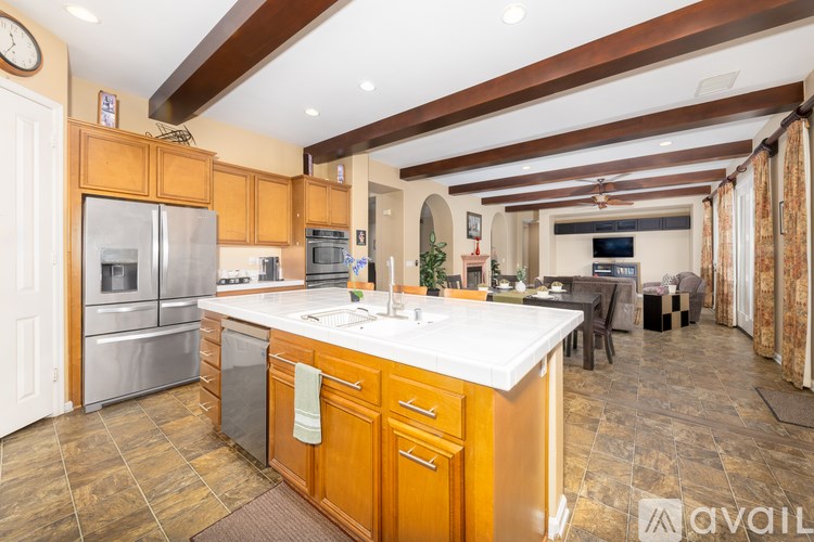 A kitchen with wooden cabinets and a white countertop.