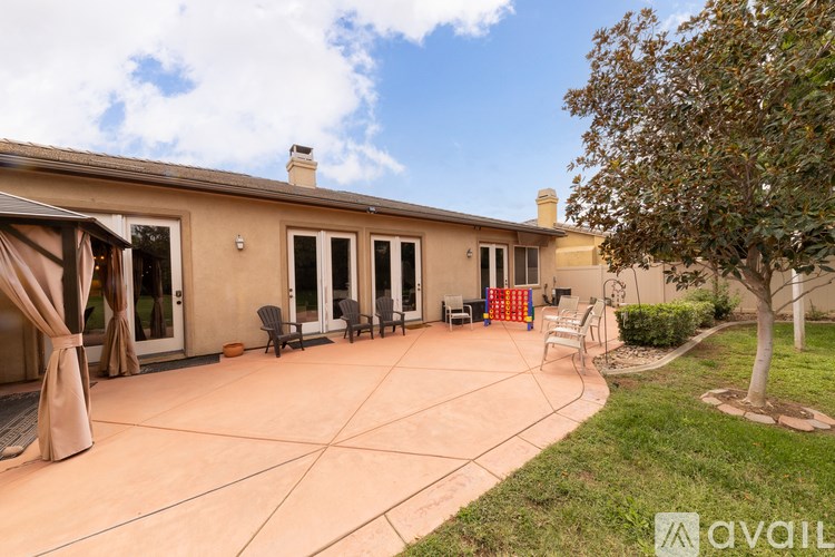A house with a patio and a tree.
