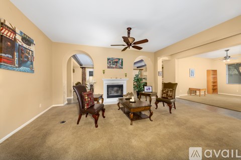 A living room with a fireplace and a painting on the wall.