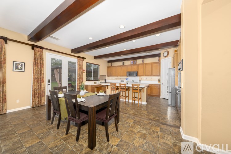 A dining room with a table set for six.