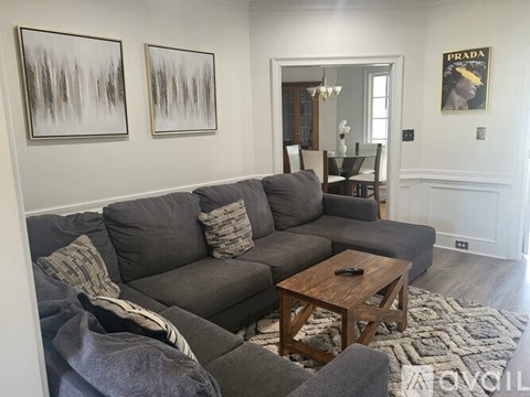 A living room with a grey couch and a coffee table.