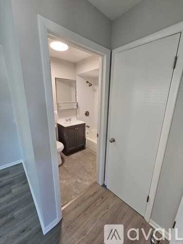 A bathroom with a toilet, sink, and a white door.