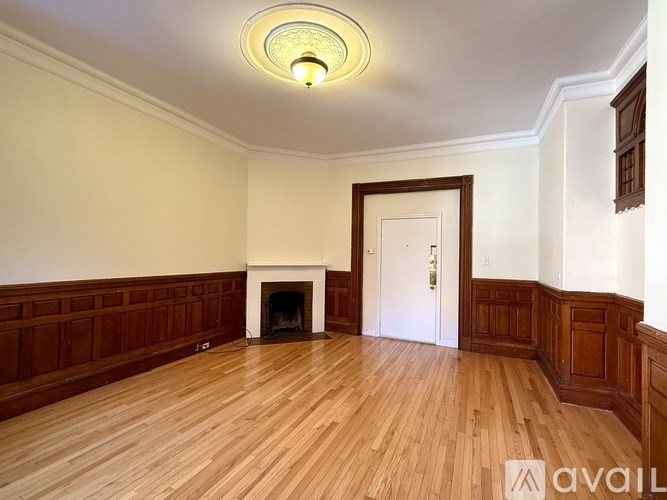 A room with wooden flooring and a sign for Cabot & Company.