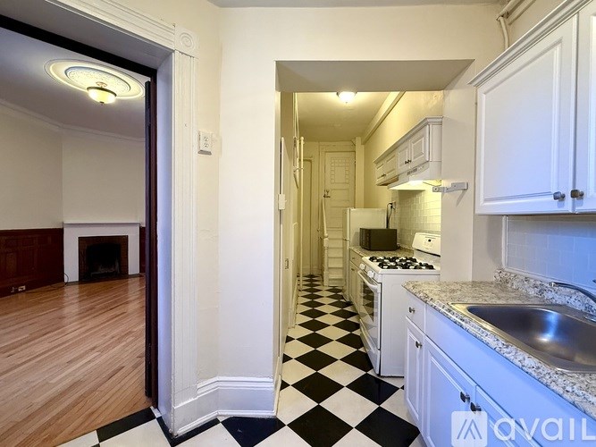 A kitchen with black and white checkered floor tiles.