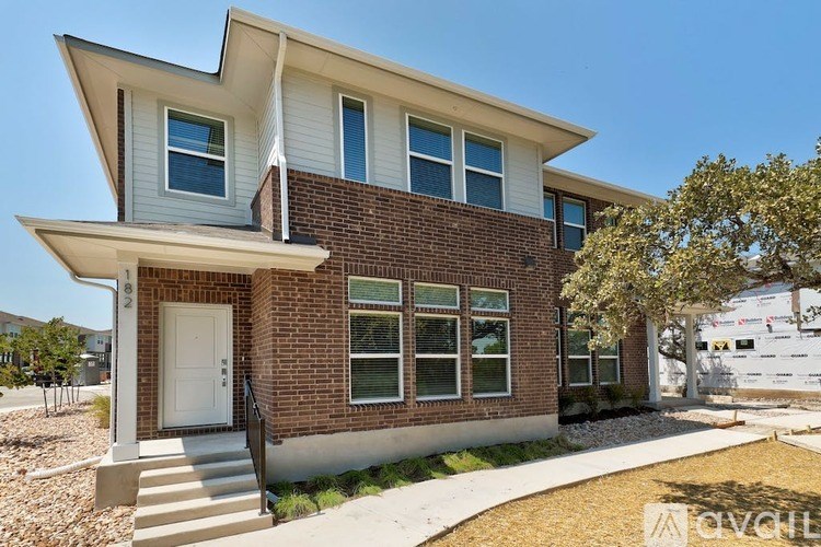 A modern house with a white door and windows.