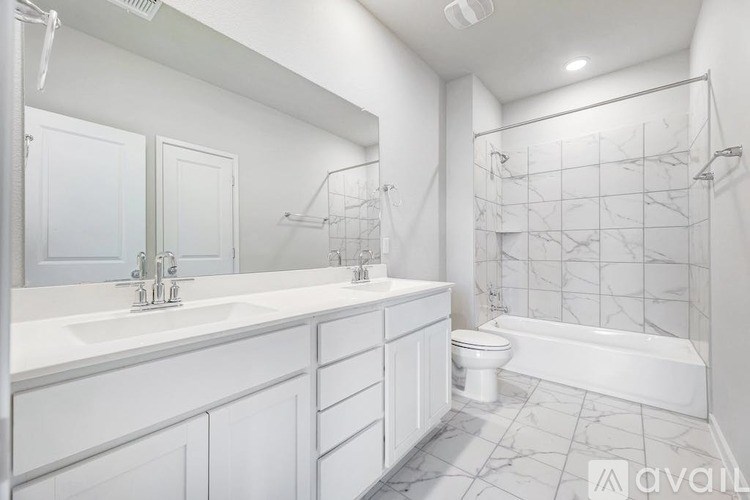 A white bathroom with a marble shower and a white bathtub.
