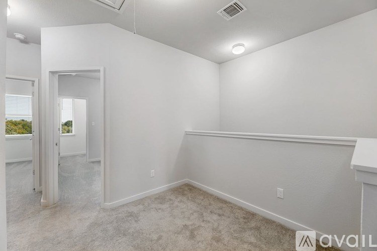 A room with white walls and carpeted floor.