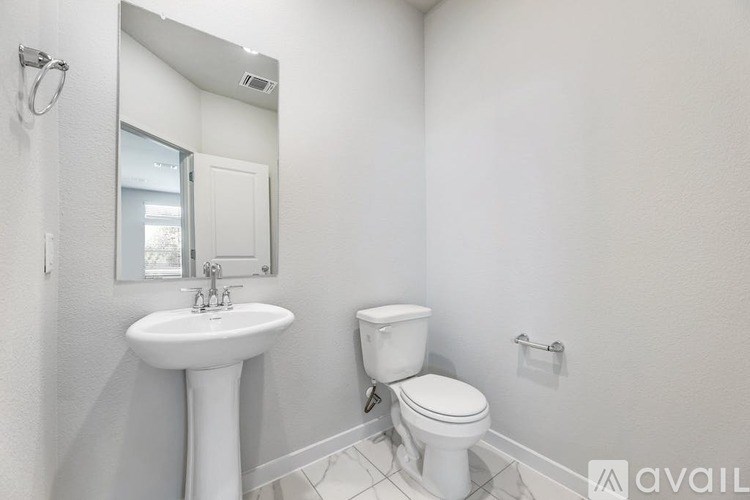 A white sink and toilet in a small bathroom.