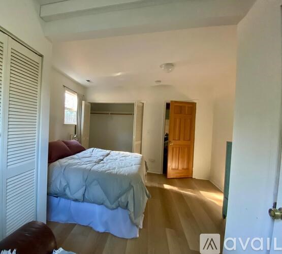 A bedroom with a bed and a wardrobe.