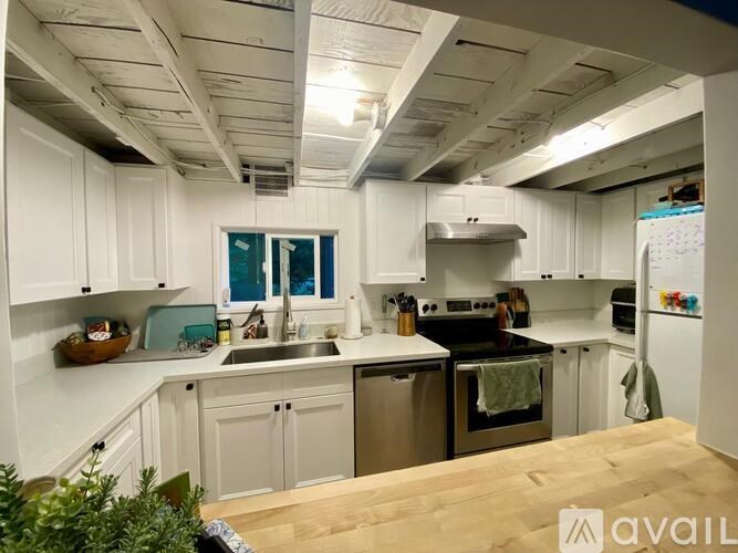 A kitchen with white cabinets and stainless steel appliances.