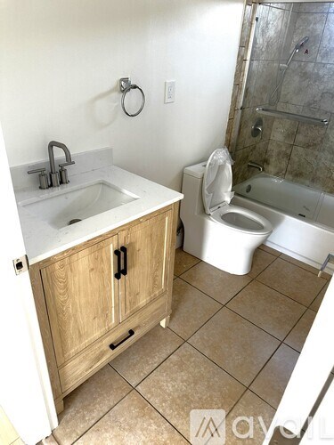 A bathroom with a sink, toilet, and bathtub.