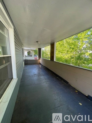 A long hallway with a window on the side.