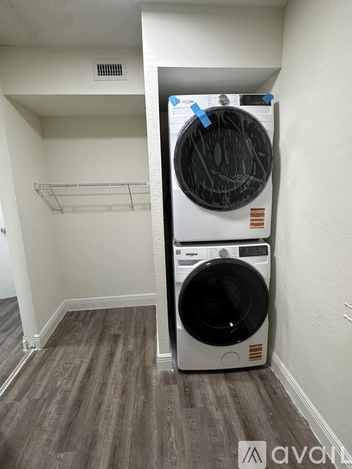 A white dryer is taped to a wall.