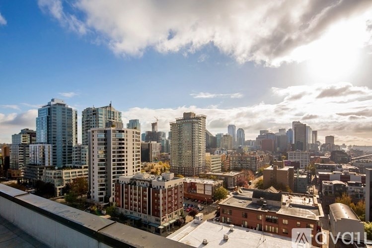 A cityscape with a mix of modern and older buildings under a partly cloudy sky.